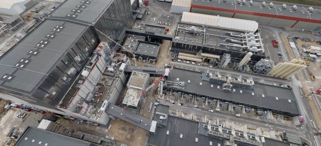 Aerial view of the two busbar bridges running from the twin Magnet Power Conversion Buildings to the Tokamak Building. The Fast Discharge building is seen above them.
