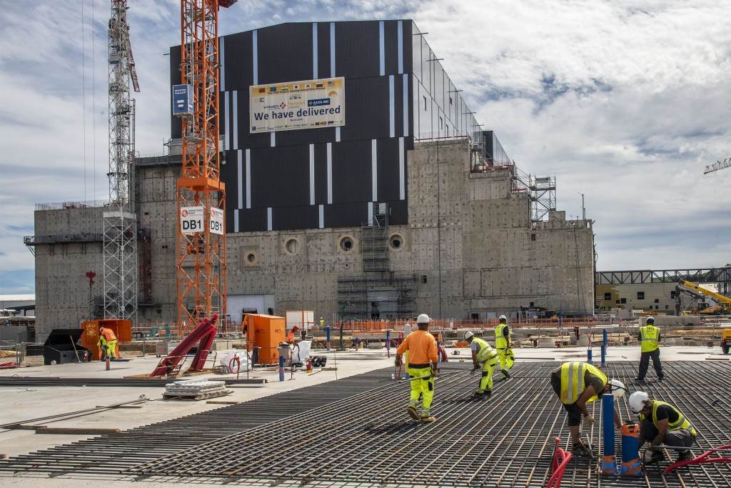 Construction teams working on the concrete slab covering the galleries before erecting the buildings. September 2022. ©ITER Organization