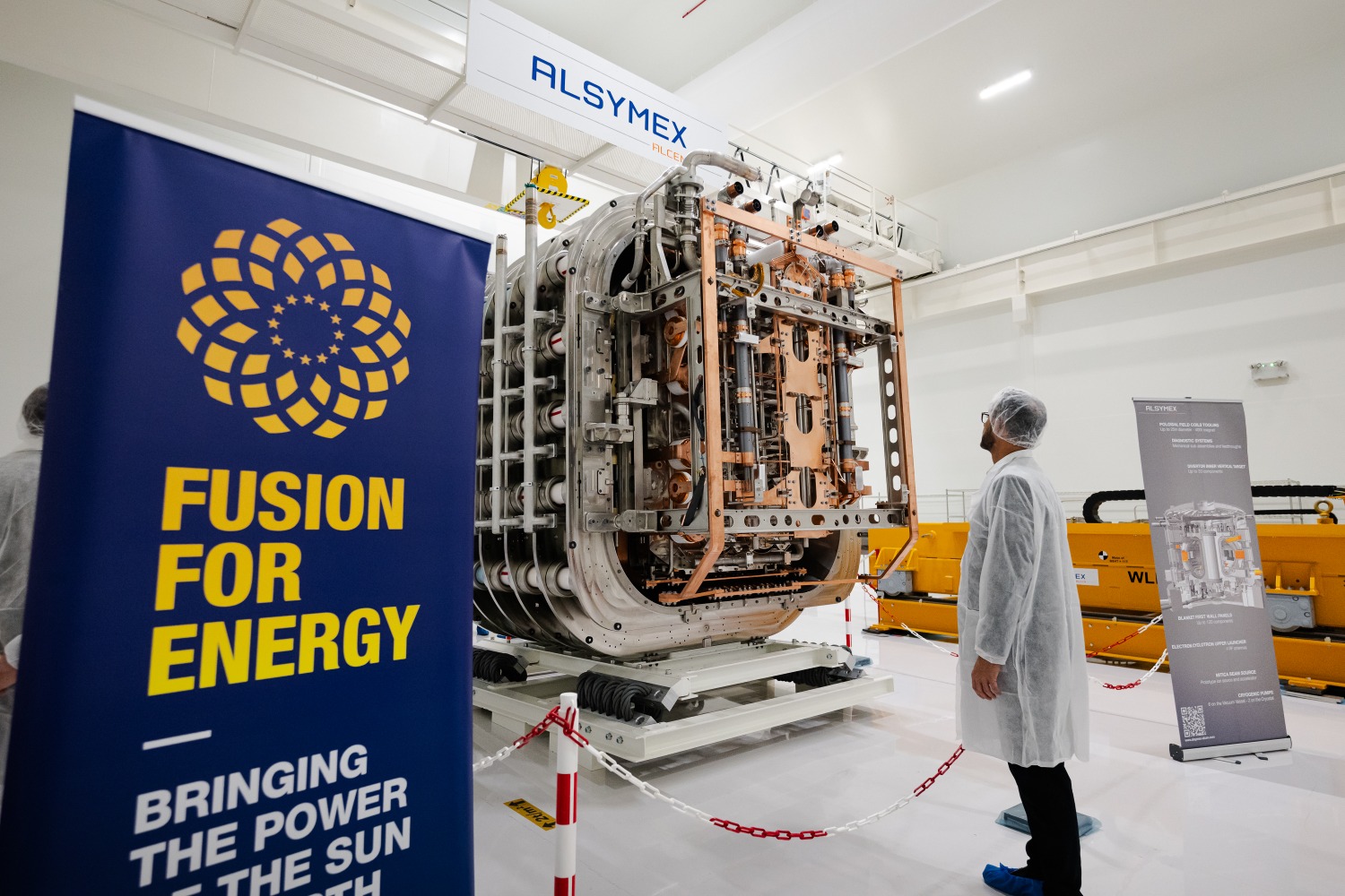 A participant in the ceremony observing the beam source up close inside the clean room. ©ALSYMEX