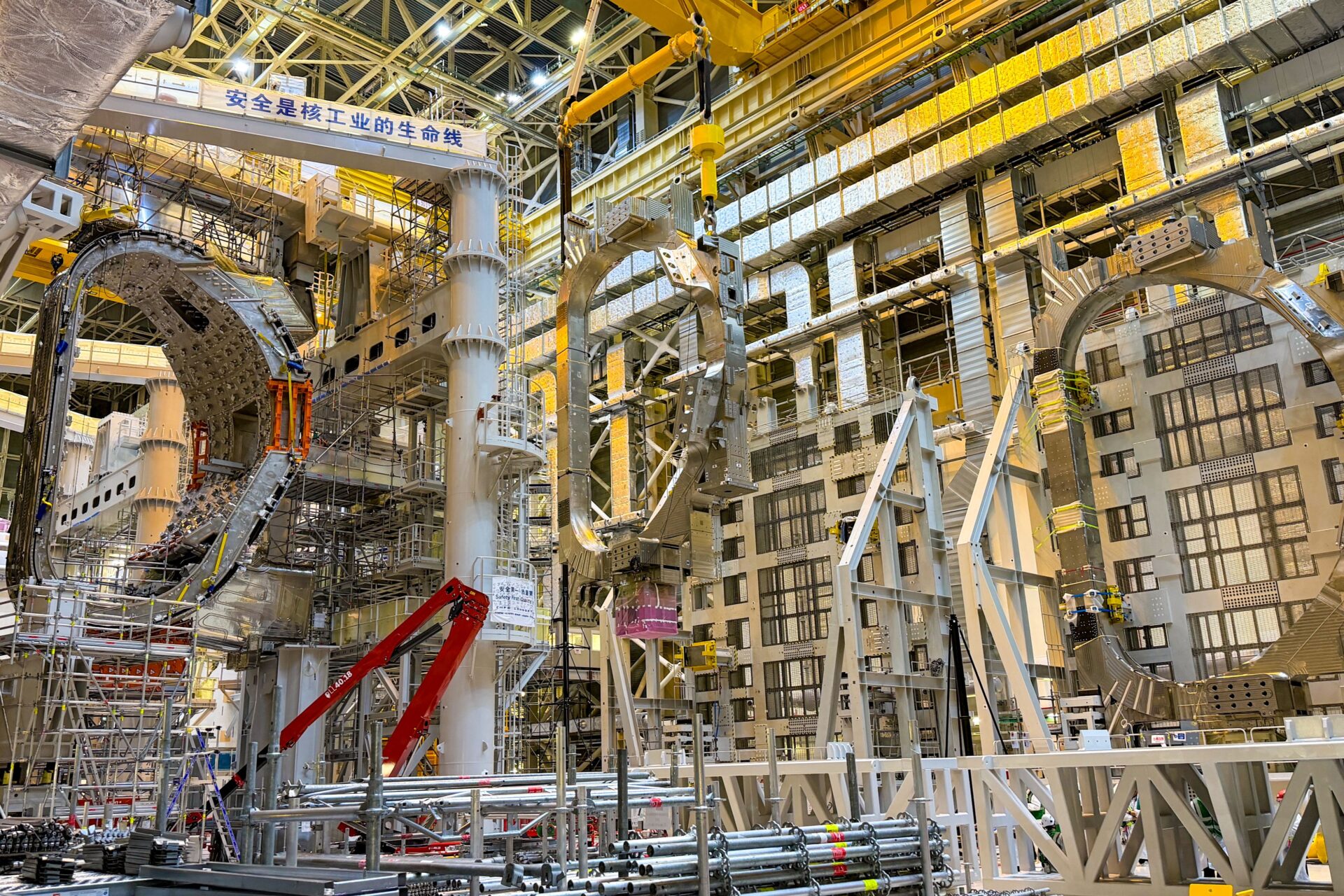 Lifting of one of the two Toroidal Field coils that were integrated with sector 9 in the Assembly Hall. July 2026 ©ITER Organization