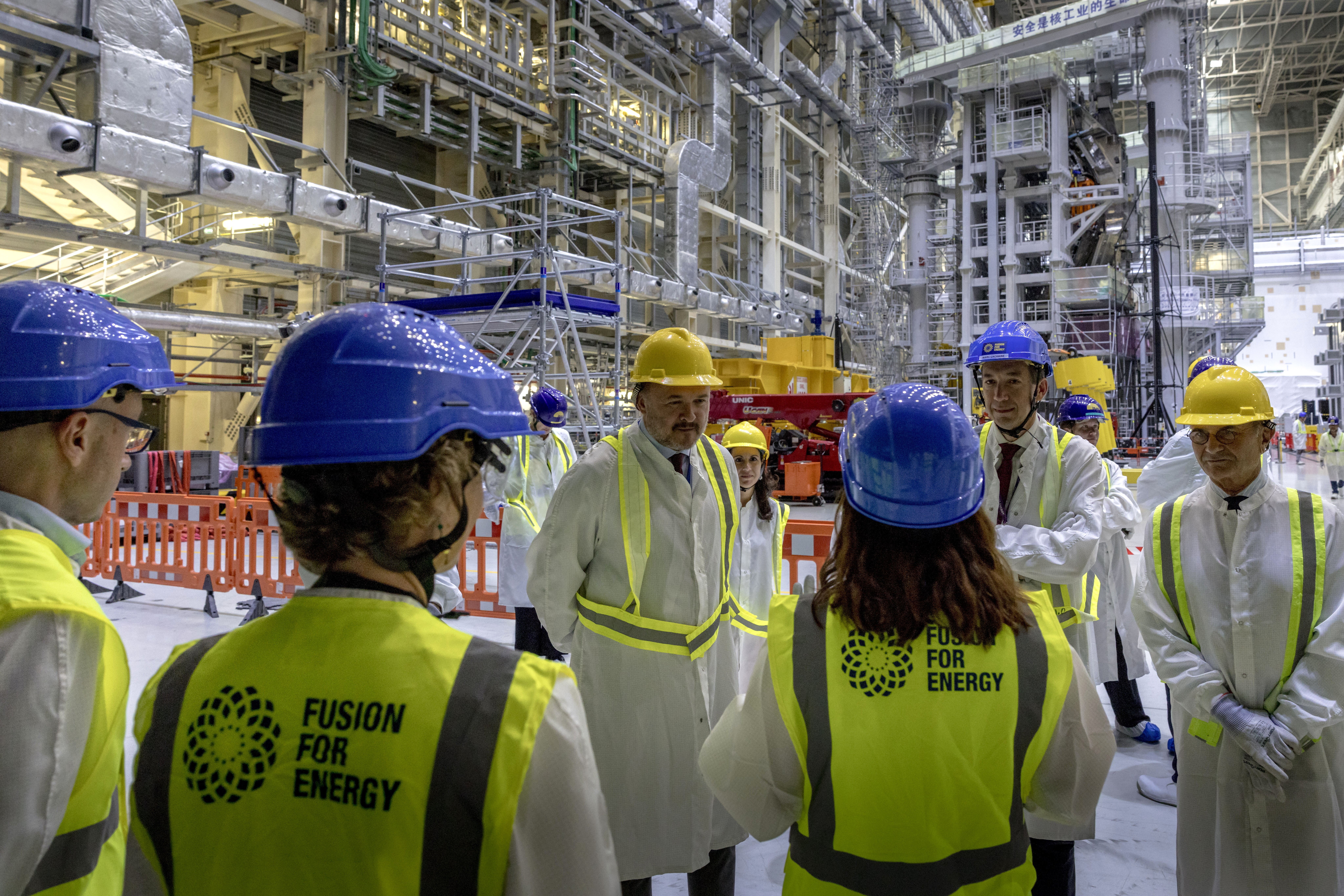 Commissioner Jørgensen discusses with F4E staff members inside the Tokamak Complex. ©ITER Organization