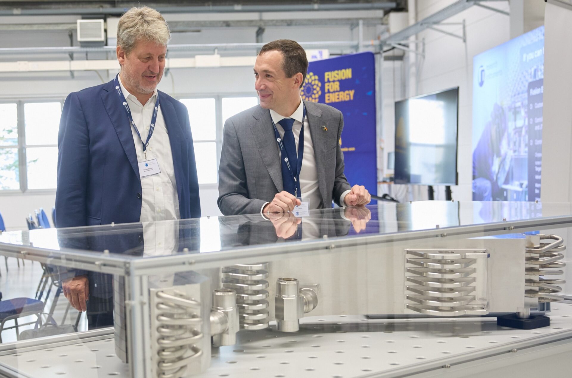 RI Managing Director, Michael Pekeler, and F4E Director, Marc Lachaise, discuss next to an IVT unit, in display during the ceremony. ©Research Instruments